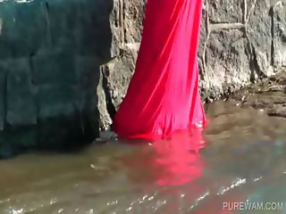 Brunette gets wet in the river