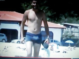 hot guy walking  on beach rubbing his bulge
