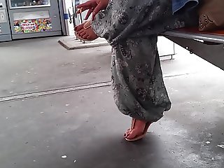 Turkish woman with hot long toenails in red